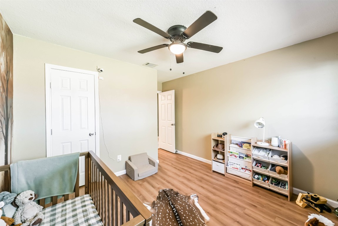 323 Coventry Lane Alvin, TX 77511 - Photo 31 of 37 a bedroom with furniture and a wooden floor