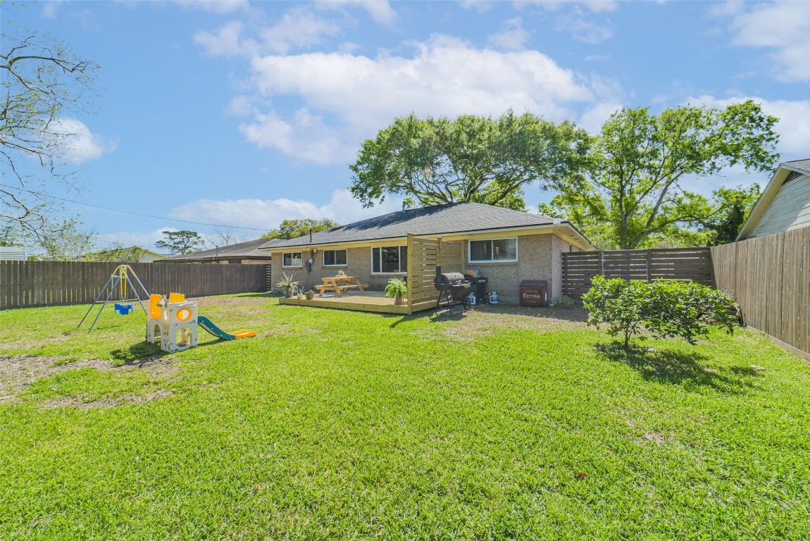 323 Coventry Lane Alvin, TX 77511 - Photo 36 of 37 a view of a house with swimming pool and a yard