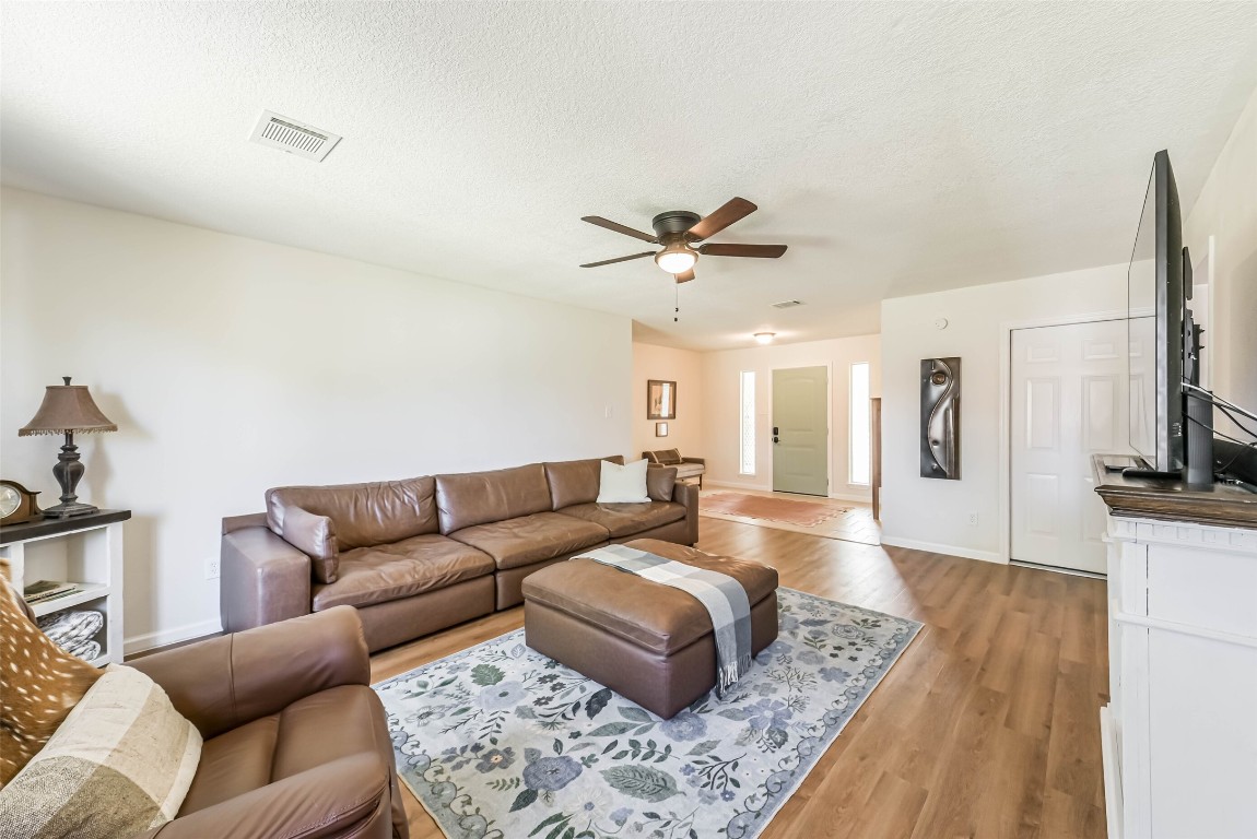 323 Coventry Lane Alvin, TX 77511 - Photo 9 of 37 a living room with furniture and a flat screen tv