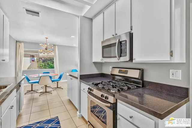 a kitchen with a stove a sink and a microwave