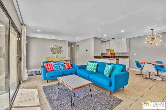 a living room with furniture and kitchen view