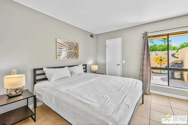 a bedroom with a bed and a painting on the wall