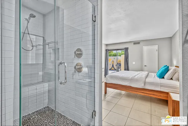 a bedroom with a bed and a shower