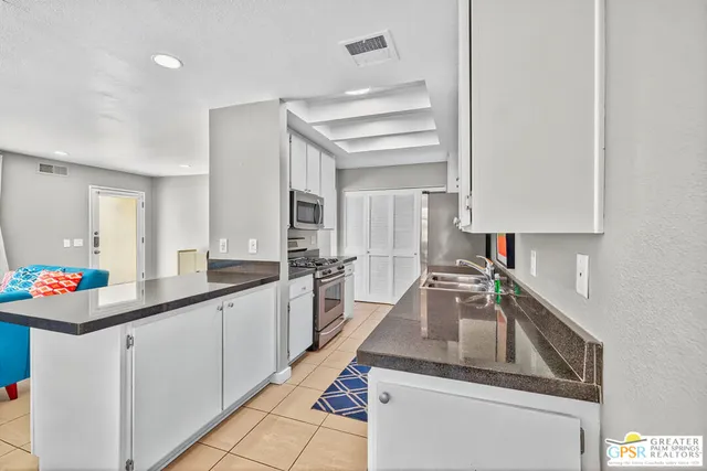 a kitchen that has a sink and a stove in it