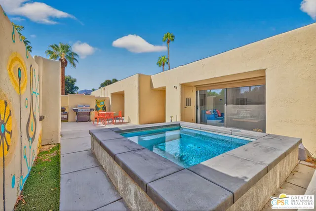 a view of swimming pool with outdoor seating
