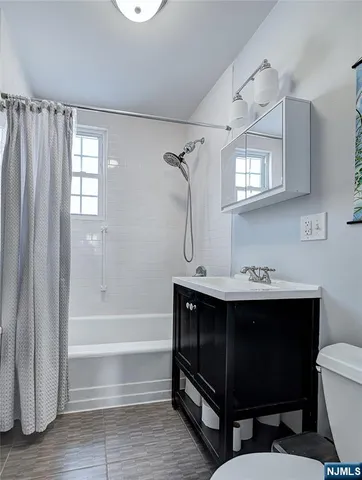 a bathroom with a sink mirror vanity and toilet