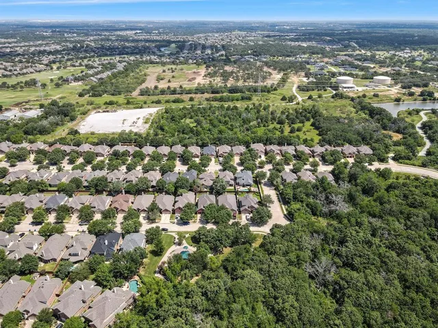 an aerial view of residential houses with city view
