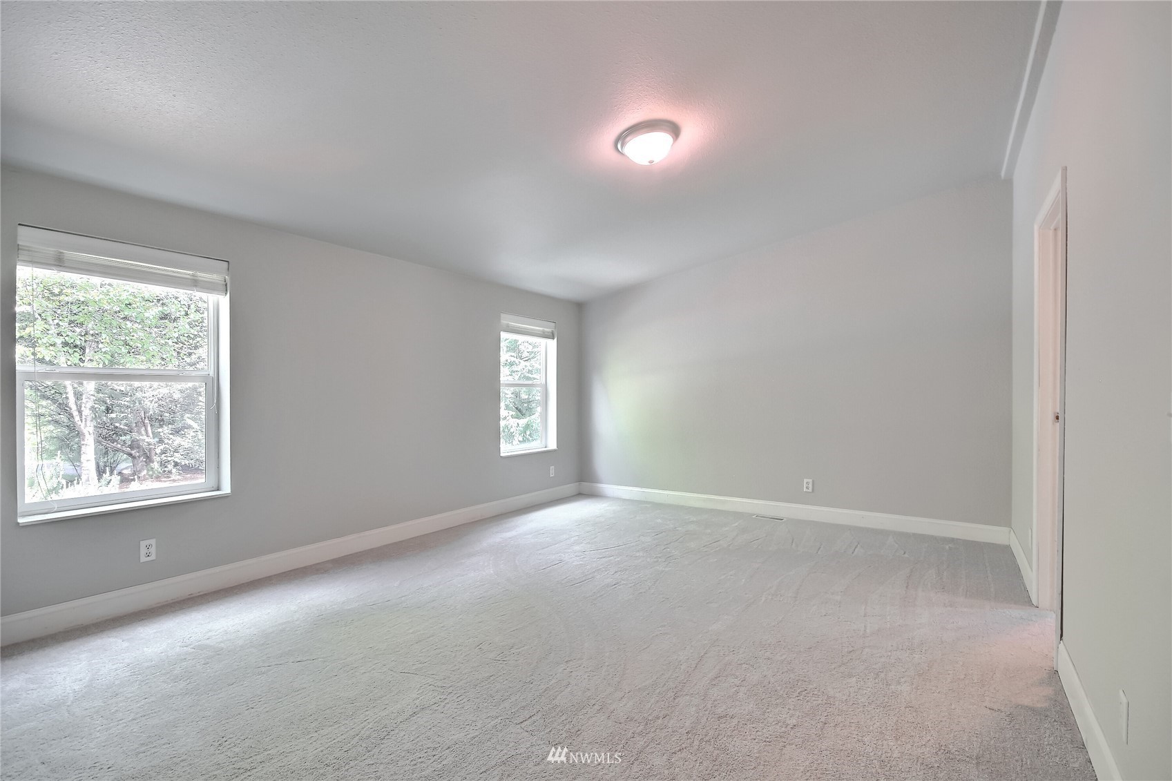 12319 Chain Lake Road Snohomish, WA 98290 - Photo 15 of 38 an empty room with windows and window