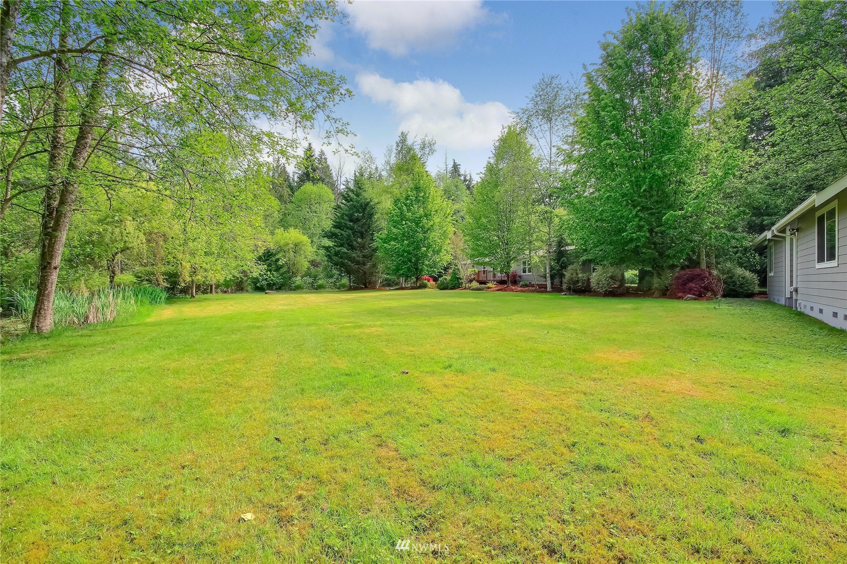 12319 Chain Lake Road Snohomish, WA 98290 - Photo 26 of 38 a view of a field with trees in the background