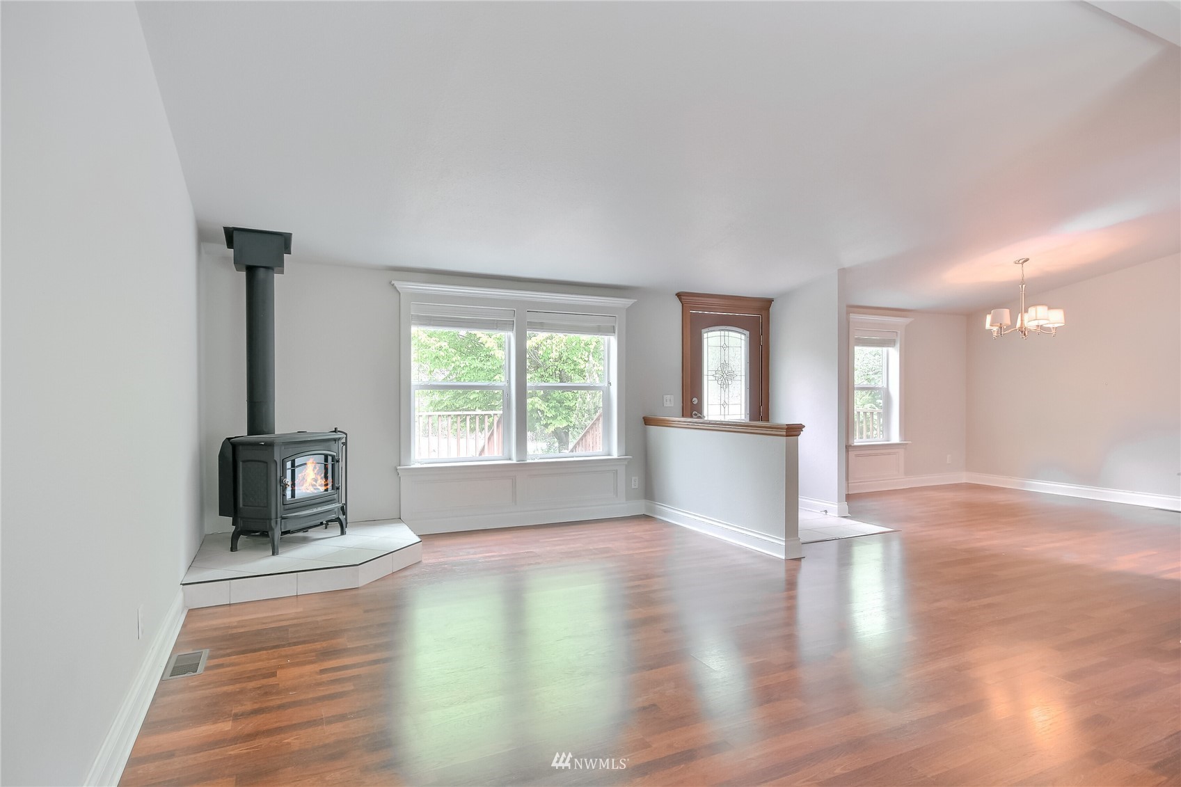 12319 Chain Lake Road Snohomish, WA 98290 - Photo 6 of 38 an empty room with windows and wooden floor