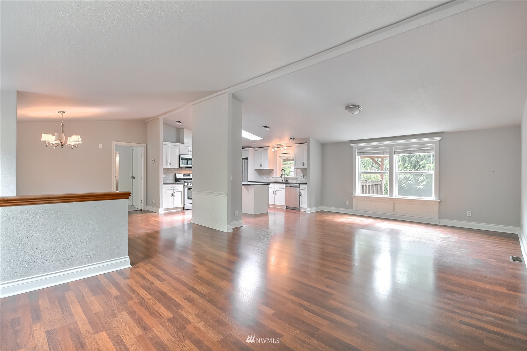 12319 Chain Lake Road Snohomish, WA 98290 - Photo 7 of 38 a view of an empty room with wooden floor and a window