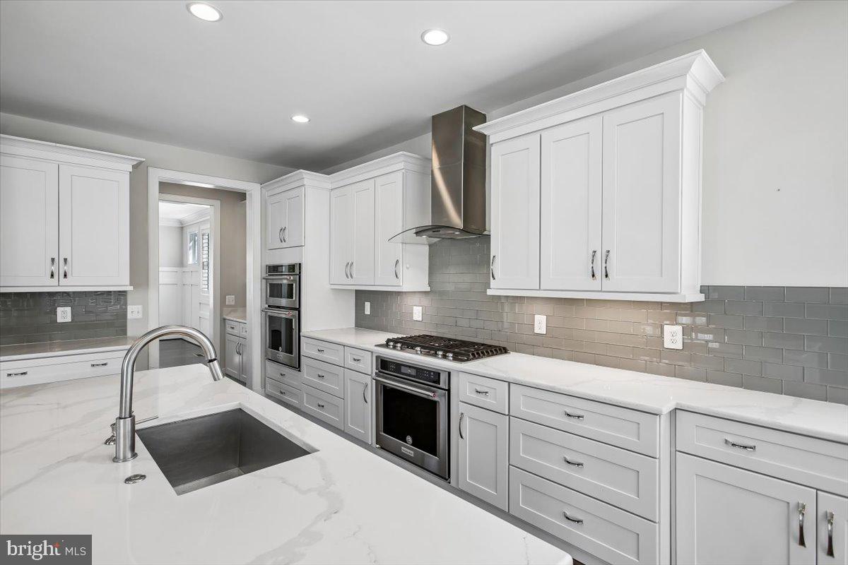 1462 Spring Vale Avenue McLean, VA 22101 - Photo 8 of 25 Sleek modern kitchen with elegant finishes.