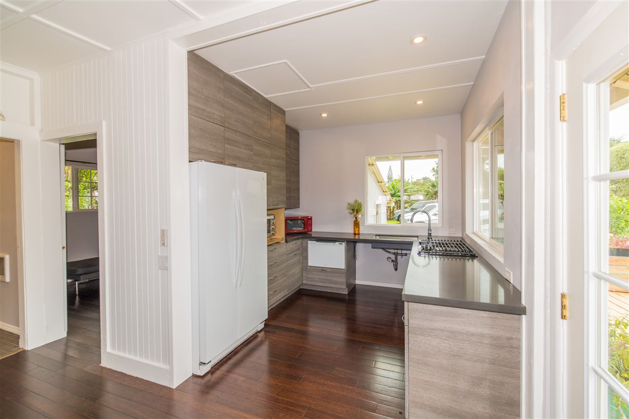 1791 Kaupakalua Road, Unit A Haiku, HI 96708 - Photo 3 of 14 a kitchen with a refrigerator and a sink