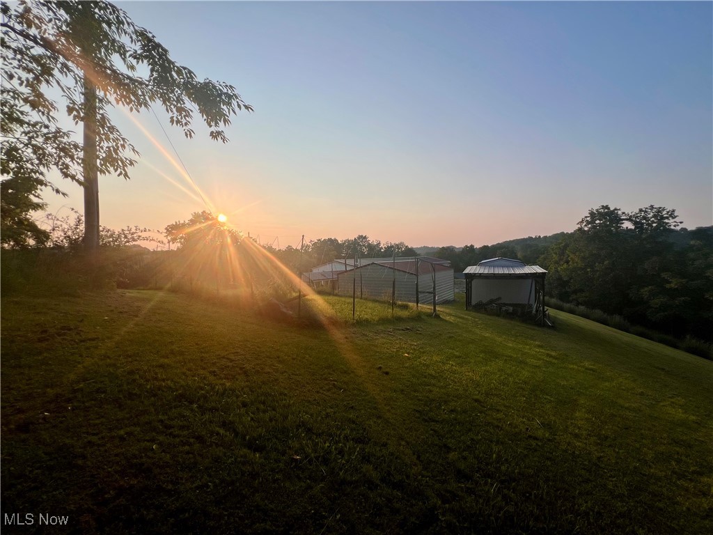 8548 Mount Carmel Rdg Road St. Marys, WV 26170 - Photo 10 of 30 Yard at dusk featuring a lawn, a large garden and workshed