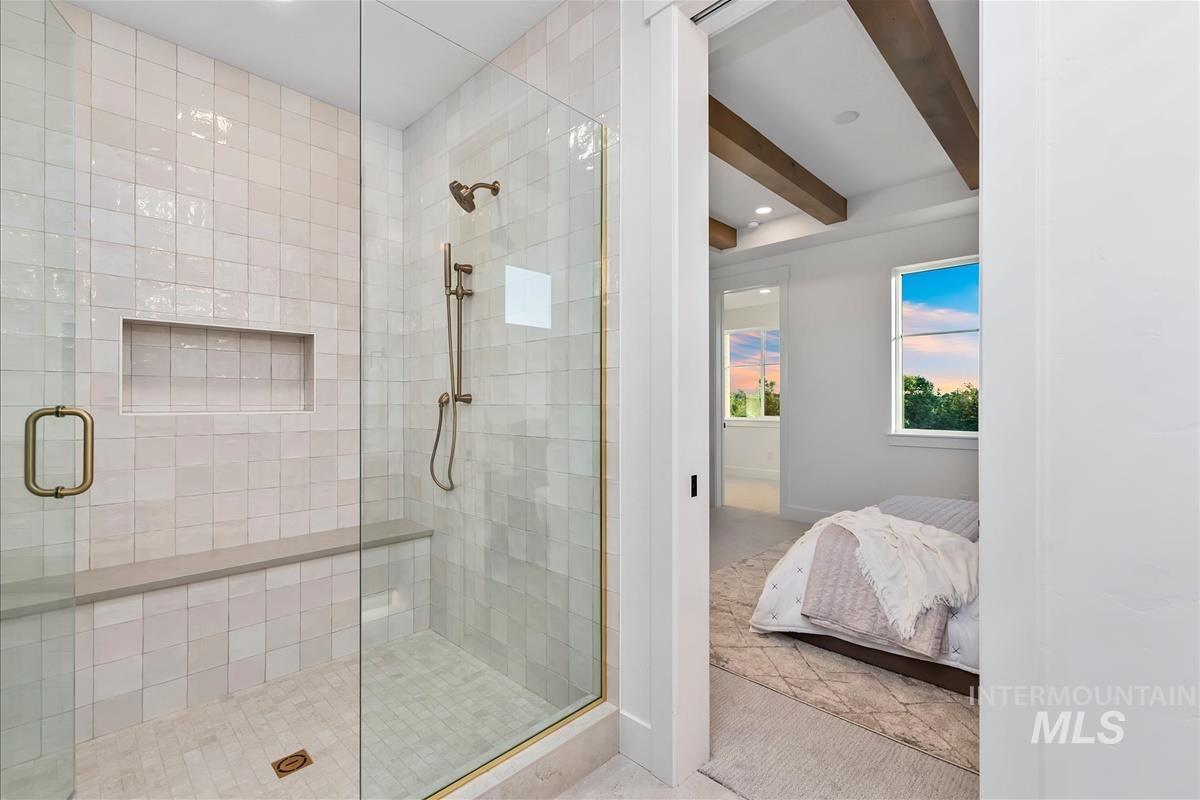 3219 West Moore Street Boise, ID 83702 - Photo 24 of 36 Glass-enclosed shower with subway tile surround, integrated niche, and built-in bench