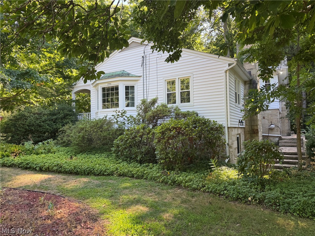 Exterior side view showing bay window and stairs to patio