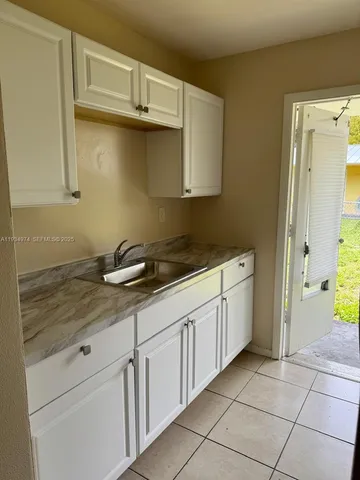 a kitchen with a stove and a refrigerator