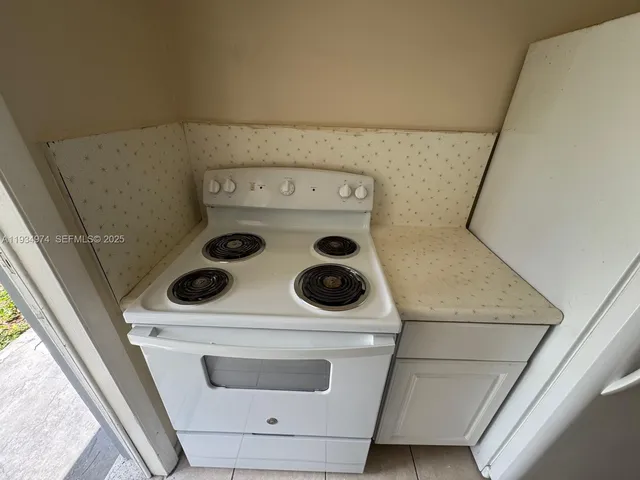 a white toilet sitting next to a bathroom sink and a mirror