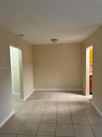 a kitchen with a stove a refrigerator and cabinets