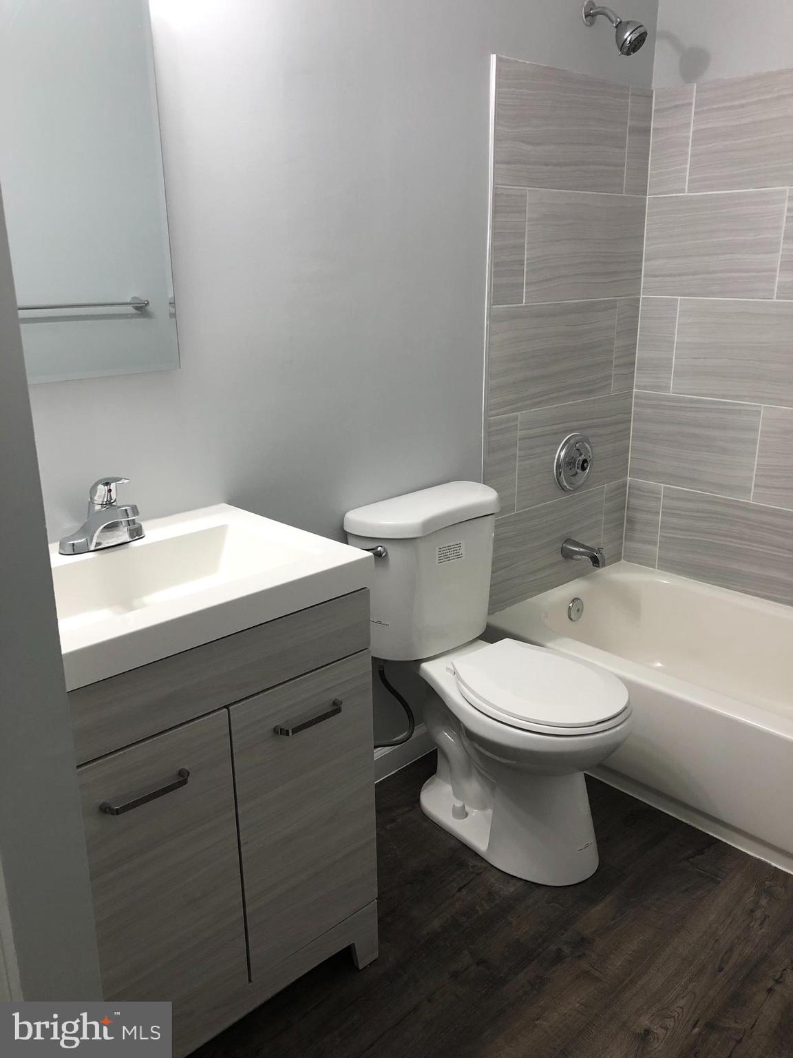 11510 Little Patuxent Parkway, Unit 407 Columbia, MD 21044 - Photo 4 of 15 a bathroom with a sink a toilet and shower