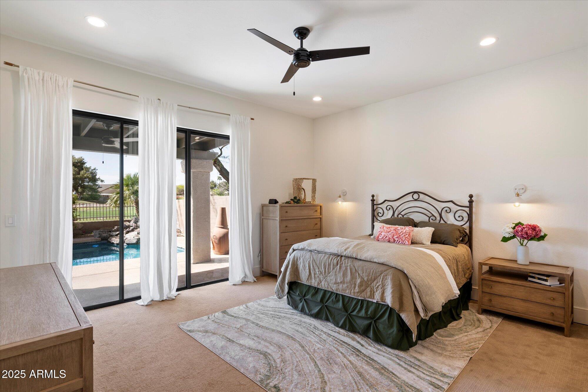 11846 North 40th Place Phoenix, AZ 85028 - Photo 16 of 37 a bedroom with a bed and a chandelier