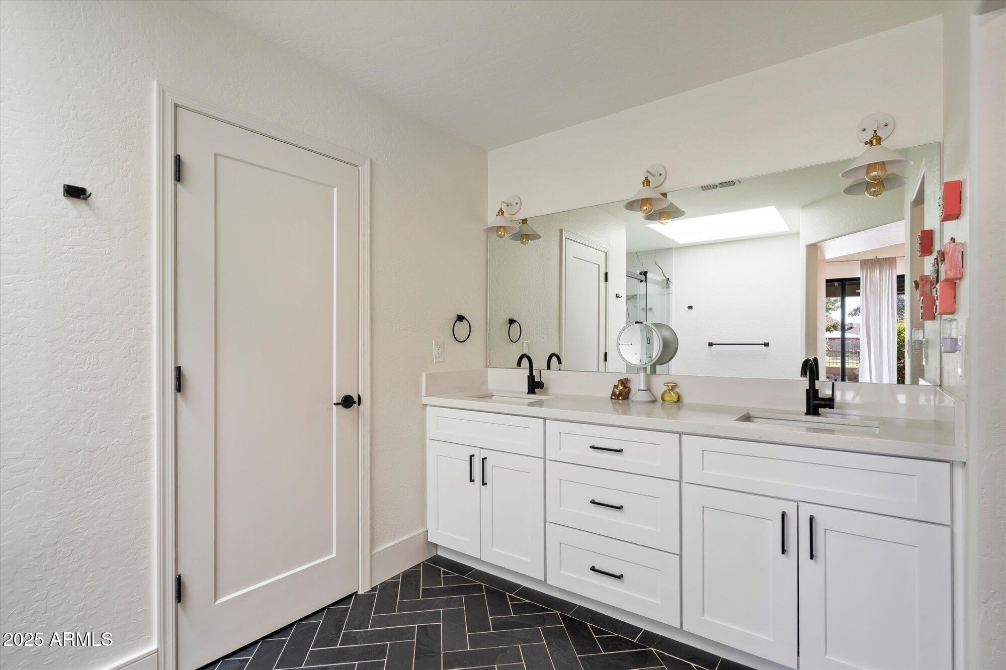 11846 North 40th Place Phoenix, AZ 85028 - Photo 18 of 37 a spacious bathroom with a double vanity sink a mirror and a shower