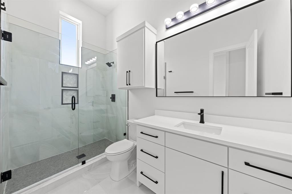 3115 Gibbs Williams Road Dallas, TX 75233 - Photo 14 of 29 a bathroom with a sink a toilet and shower