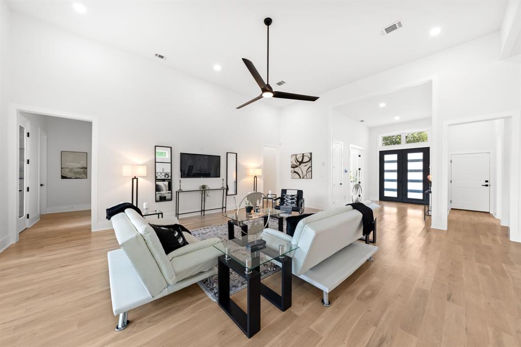 3115 Gibbs Williams Road Dallas, TX 75233 - Photo 4 of 29 a spacious bedroom with a bed a couch and a flat screen tv