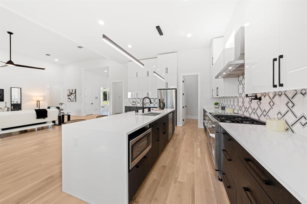 3115 Gibbs Williams Road Dallas, TX 75233 - Photo 7 of 29 a large kitchen with stainless steel appliances lots of counter space and a sink