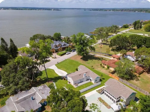 an aerial view of a house with a lake view