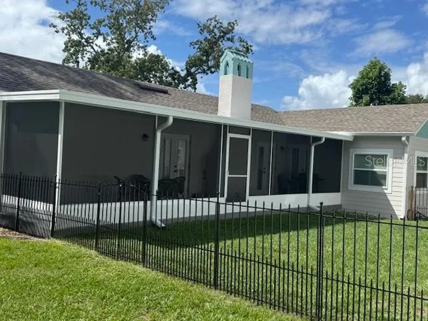 a view of a house with a small yard and a large window
