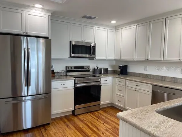a kitchen with a refrigerator sink and microwave
