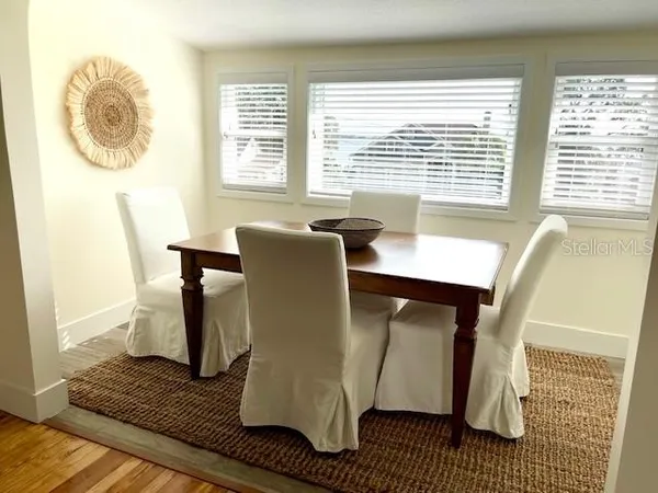 a dining room with furniture and window