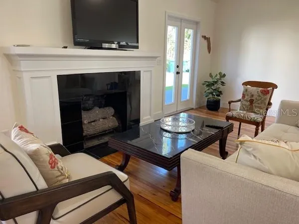 a living room with furniture and a fireplace