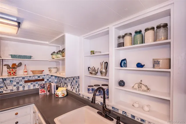 a dining room with stainless steel appliances lots of wooden furniture