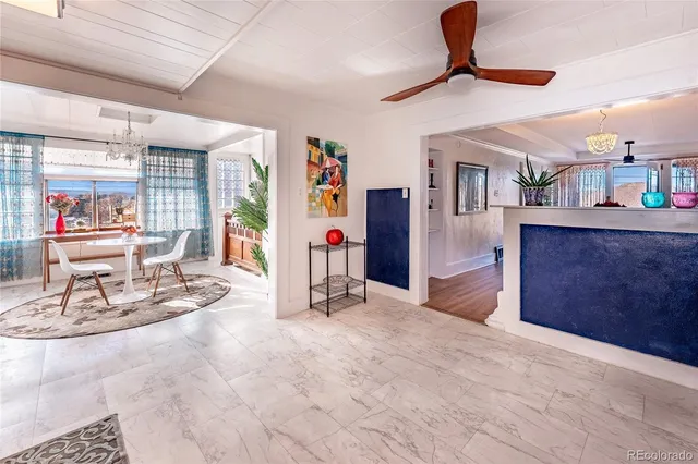 a view of a livingroom with furniture and a ceiling fan