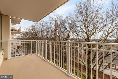 a view of a balcony with wooden fence and floor