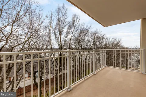 a view of a balcony with wooden fence and floor