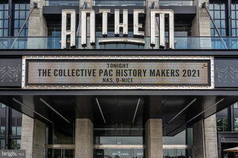 a front view of a house with a yard and an trees