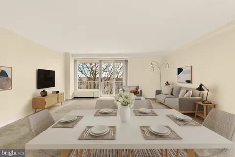 a living room with furniture a flat screen tv and a large window