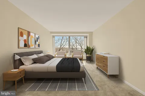 a bedroom with a bed and a large window
