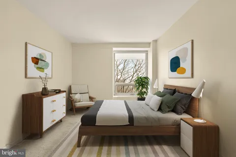 a bed room with a bed and a painting on the wall