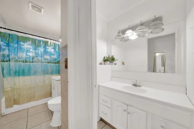 a bathroom with a sink a toilet and a shower