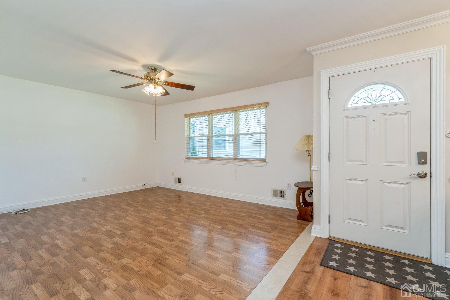 39 Haven Drive Old Bridge, NJ 07747 - Photo 4 of 16 wooden floor in an empty room with a window