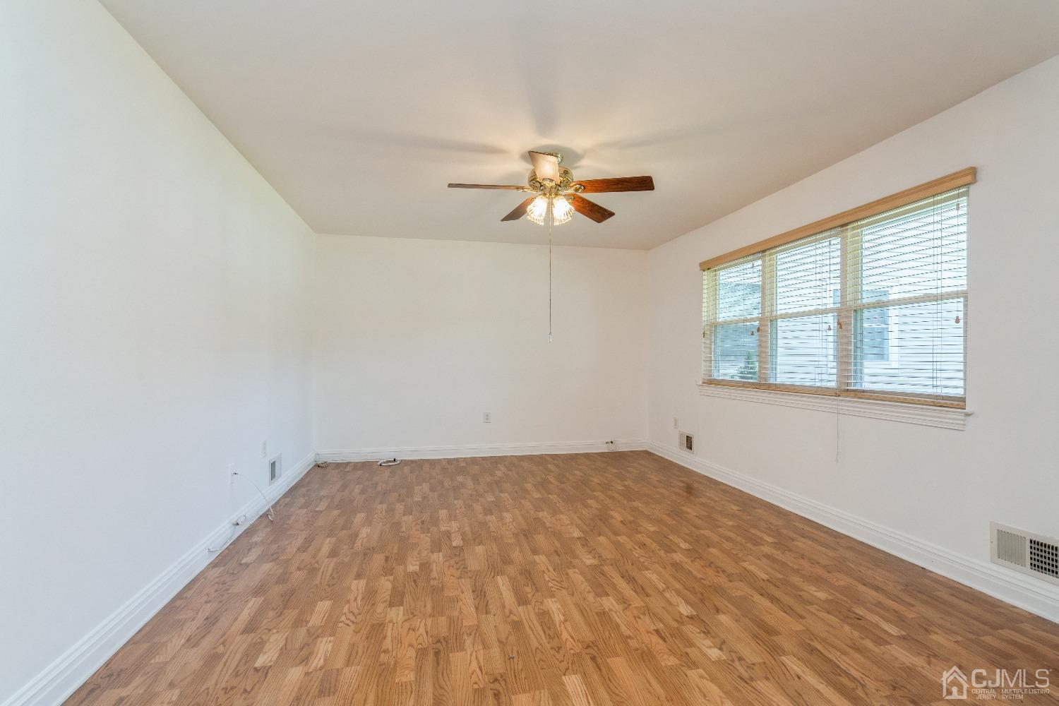 39 Haven Drive Old Bridge, NJ 07747 - Photo 5 of 16 an empty room with a window and a fan