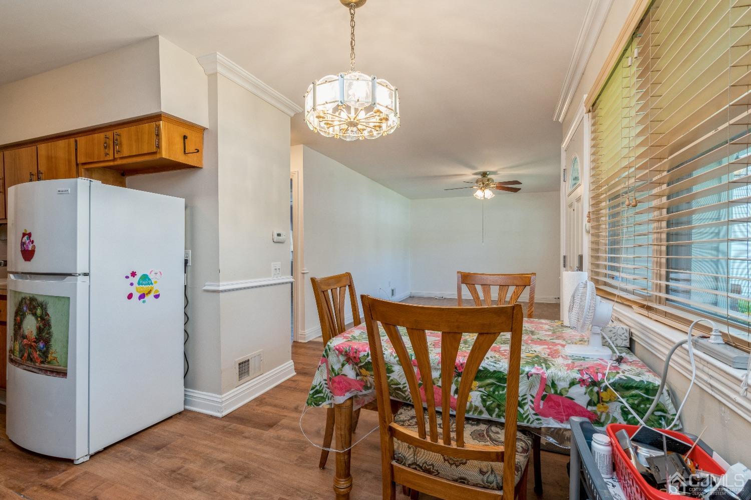 39 Haven Drive Old Bridge, NJ 07747 - Photo 6 of 16 a view of a dining room with furniture wooden floor and a chandelier