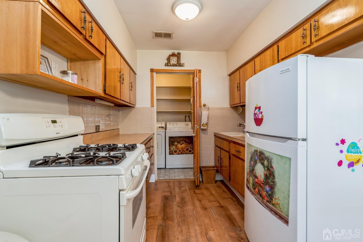 39 Haven Drive Old Bridge, NJ 07747 - Photo 7 of 16 a kitchen with a stove and a white refrigerator