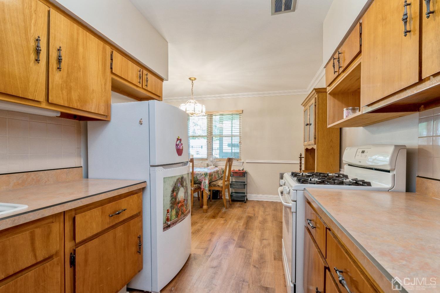 39 Haven Drive Old Bridge, NJ 07747 - Photo 8 of 16 a kitchen with a sink a stove and a refrigerator