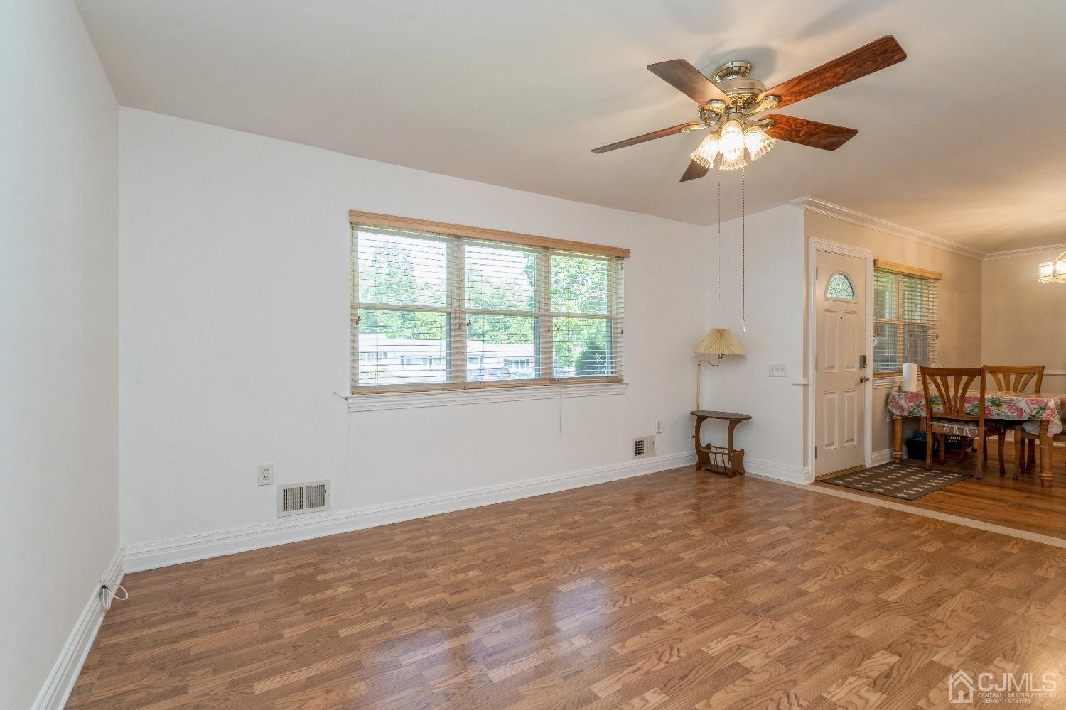 39 Haven Drive Old Bridge, NJ 07747 - Photo 10 of 16 an empty room with chandelier fan and windows
