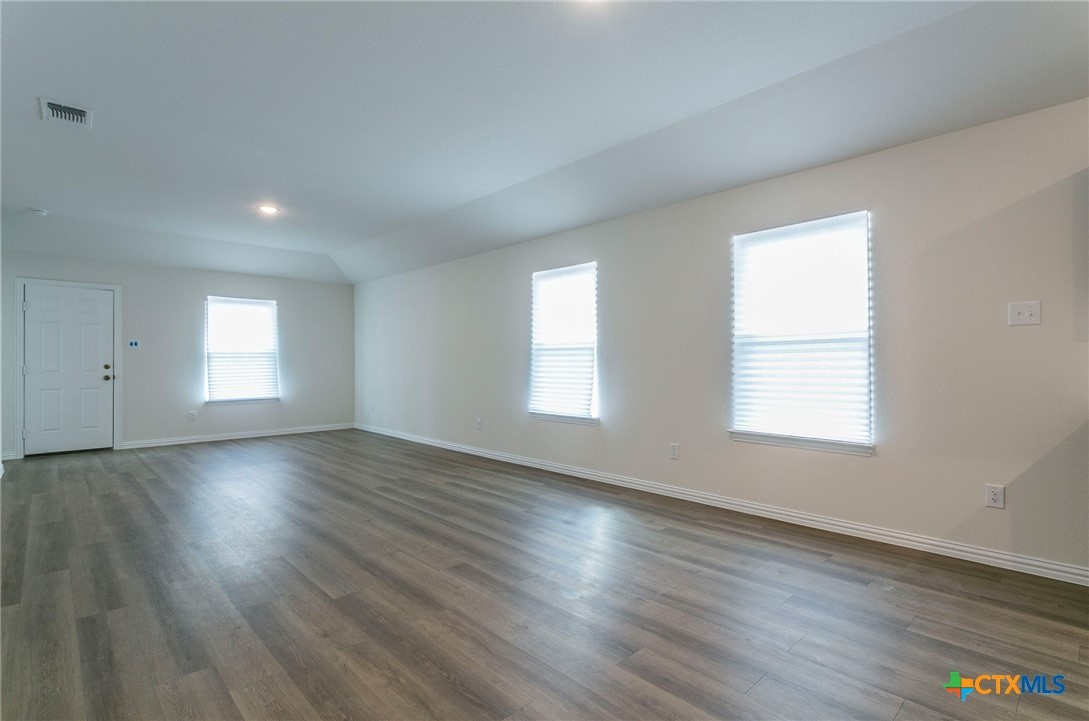 3009 Gillespie Court Temple, TX 76501 - Photo 4 of 13 an empty room with wooden floor and windows